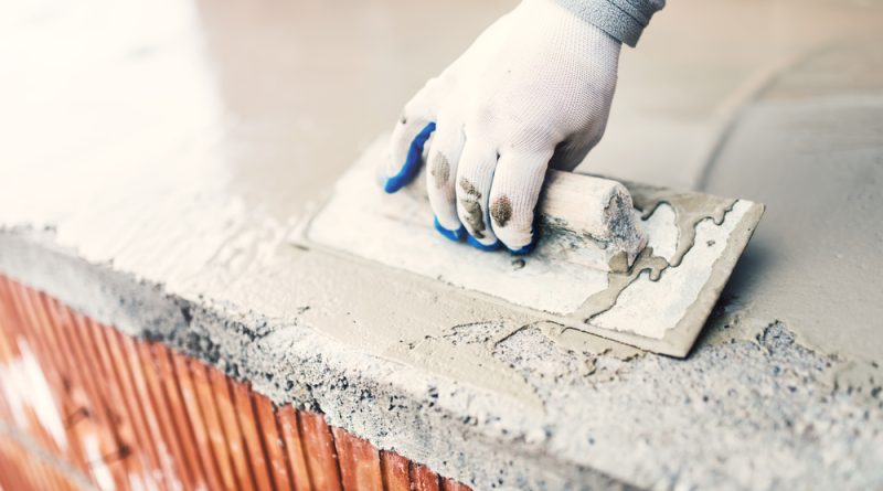Photo of a man working with cement