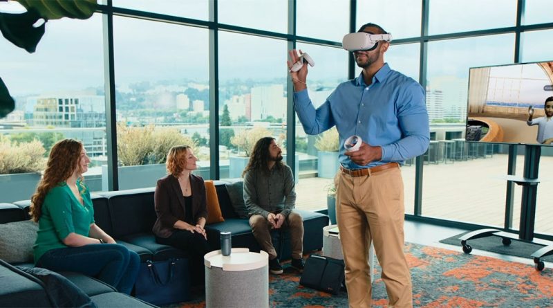 Image of a man stood in an office with an virtual reality headset on surrounded by other professionals to support construction collaboration article