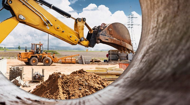 Image of a view through a cement mixer middle showing different construction machinery on a building site to support construction equipment article