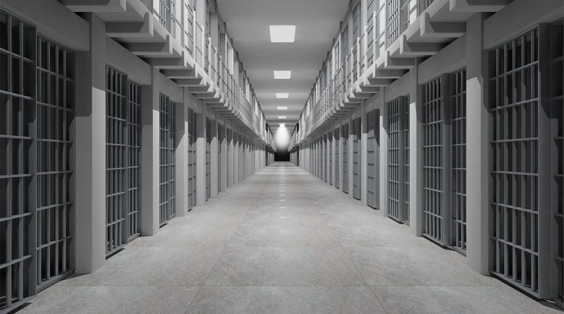 Image of a modern hallway in a prison with numerous cells either side to support new construction article