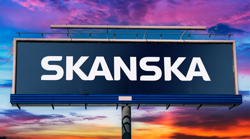 The Skanska USA sign being displayed in front of a multi-coloured sunset