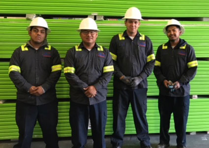 Action Gypsum workers standing in front of green gypsum boards