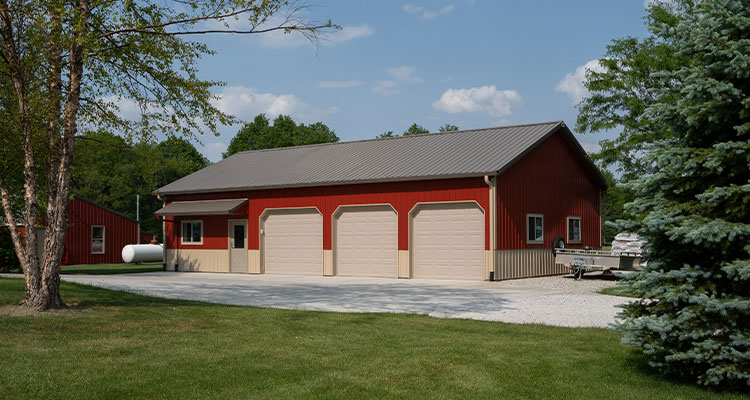 Red building with 3 white garage doors