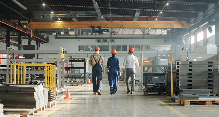 Three workers walking through a warehouse