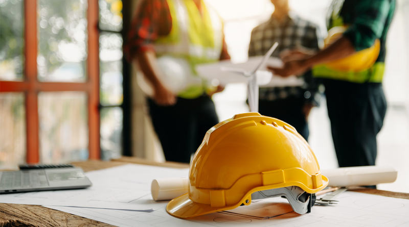 hardhat on table at work site with construction training happening