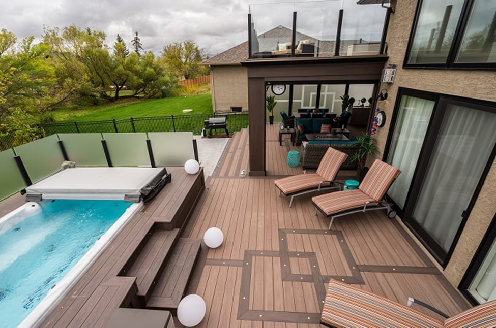 Outdoor decking area with pool by Wolf Home Products