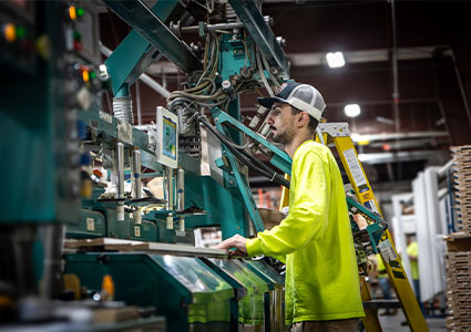  a worker operating industrial machinery