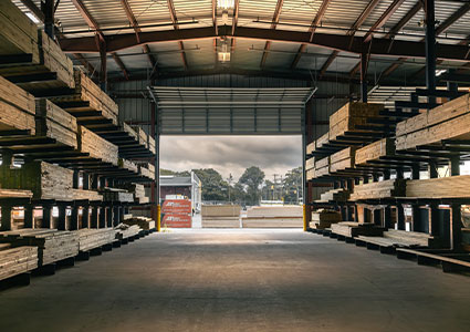 the interior of a large, industrial lumber yard warehouse