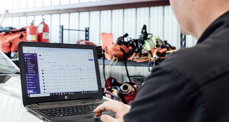 a person working on a laptop, industrial or inventory management software