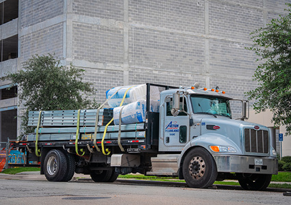 a flatbed truck delivering construction materials
