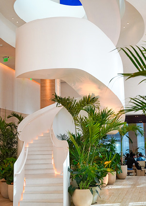 the white spiral staircase in the lobby of The Tampa EDITION hotel