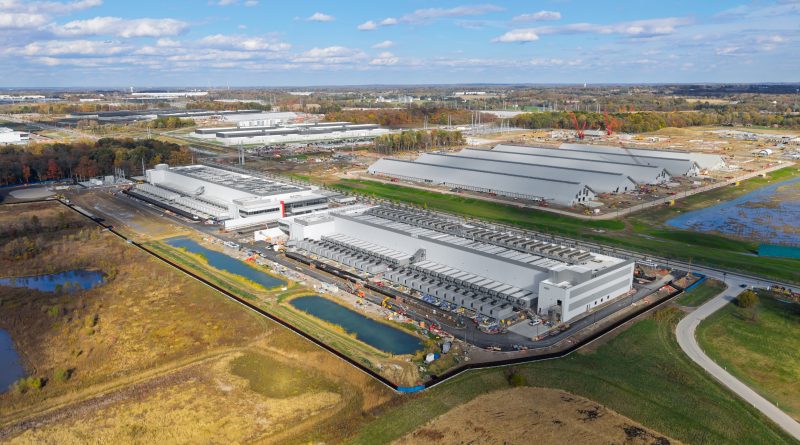 Construction workers installing infrastructure at a large AI data center project in the US.