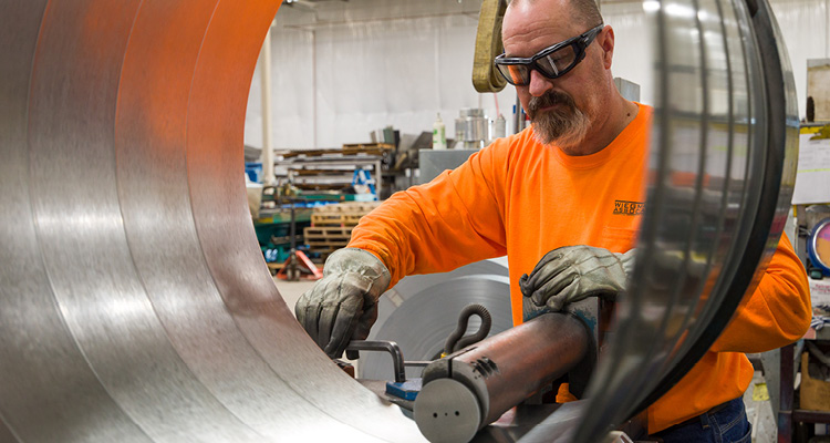 machinist or metal fabrication specialist operating complex precision equipment