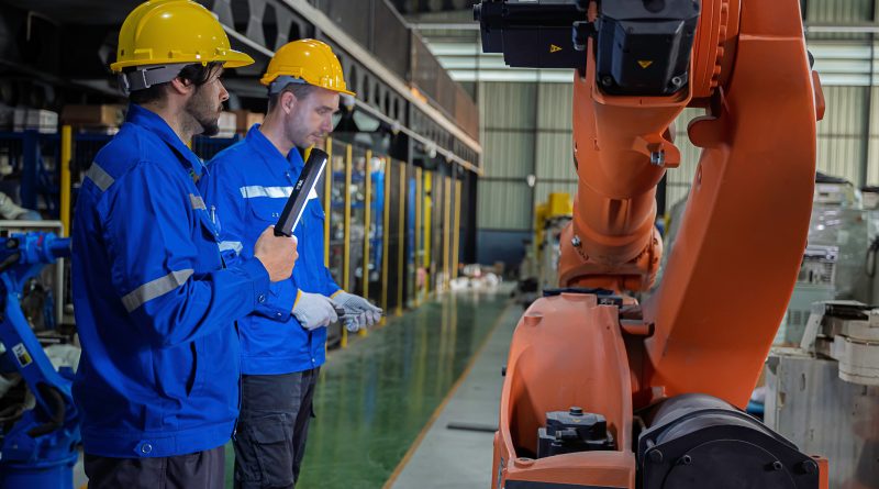 Researchers work with robotic construction systems inside the University of Florida's industrialized construction laboratory developed in partnership with Autodesk.