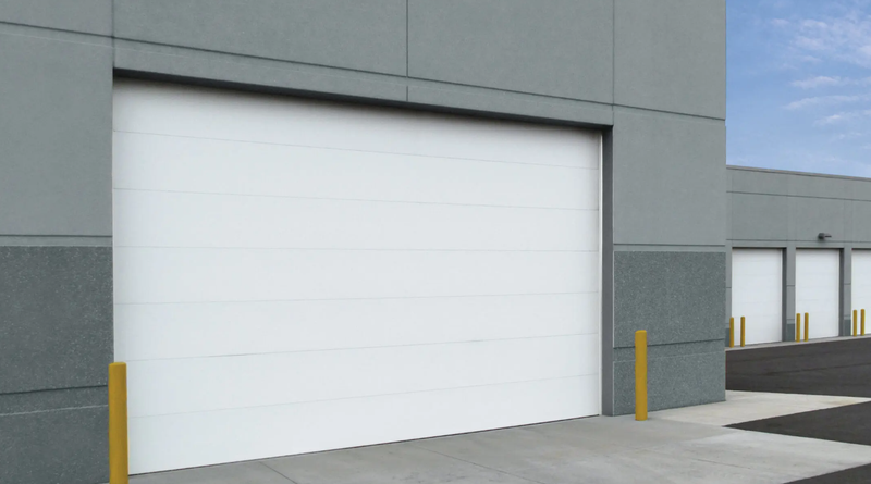 High-cycle commercial overhead doors installed at an industrial facility, designed for frequent daily use in loading dock environments.