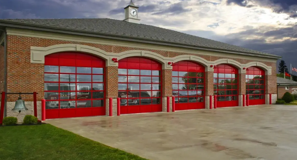 Fire station equipped with Halo Overhead's high-cycle aluminum doors featuring full-view glass panels for visibility and rapid emergency response.