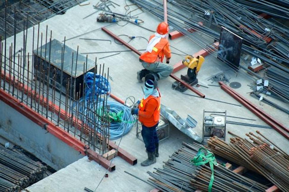 Construction workers investigating environmental threats to infrastructure