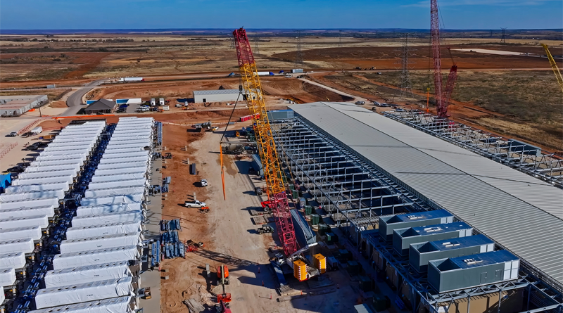 Aerial view of data center construction with BESS batteries and red cranes