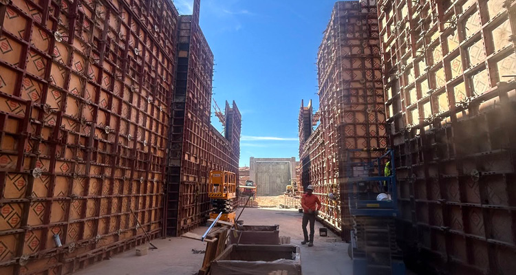 a construction site using modular concrete wall formwork to build tall cast-in-place concrete structures