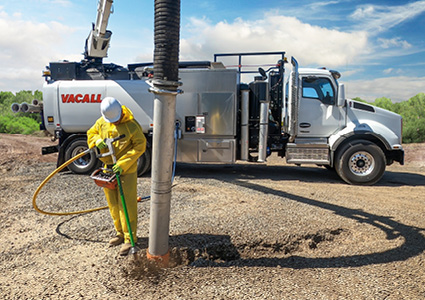 a worker operating a Vacall AllExcavate / AllExcavate2 vacuum excavator truck to perform non-destructive digging around underground utilities