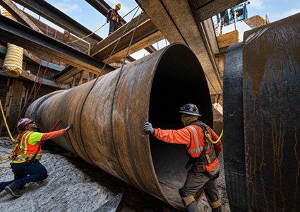Crews install large-diameter steel and earthquake-resistant pipe